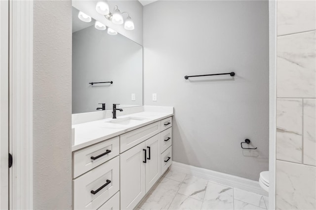 bathroom with marble look tile flooring, vanity, baseboards, and toilet