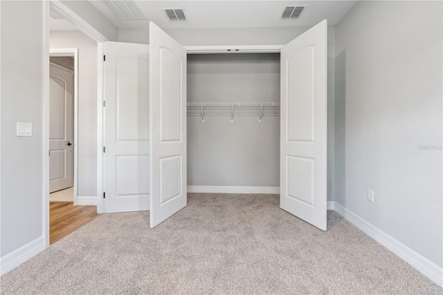 unfurnished bedroom with carpet floors, a closet, and baseboards