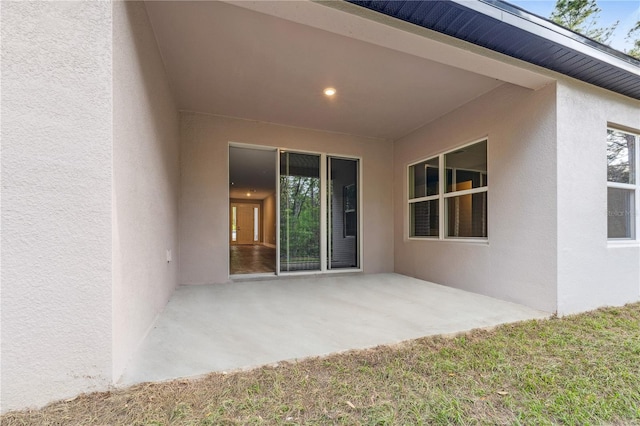 back of house featuring stucco siding and a patio