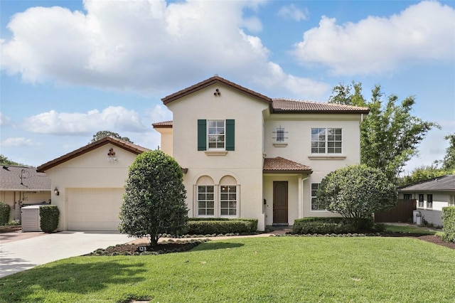 mediterranean / spanish-style house with a tiled roof, driveway, stucco siding, and a front yard