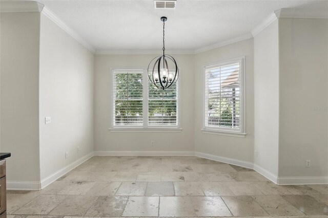 unfurnished dining area with a chandelier, stone tile floors, plenty of natural light, baseboards, and crown molding