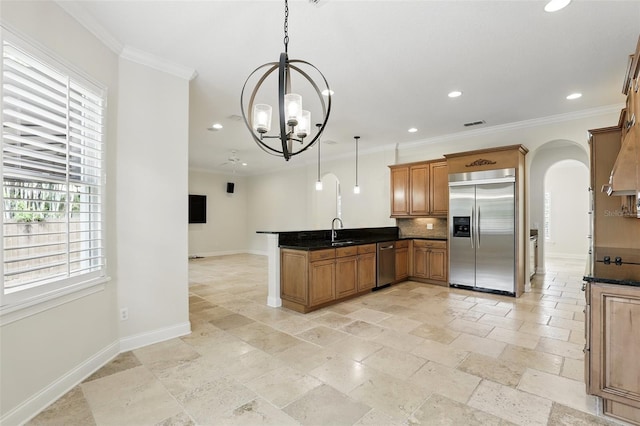 kitchen with stainless steel appliances, a peninsula, recessed lighting, baseboards, and a sink