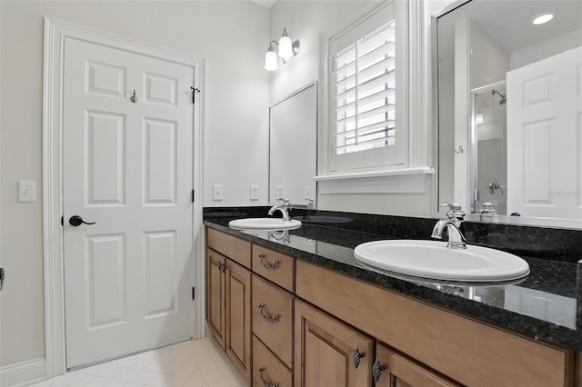 full bathroom with a stall shower, double vanity, and tile patterned floors