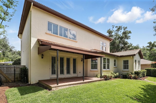 back of house featuring stucco siding and a patio