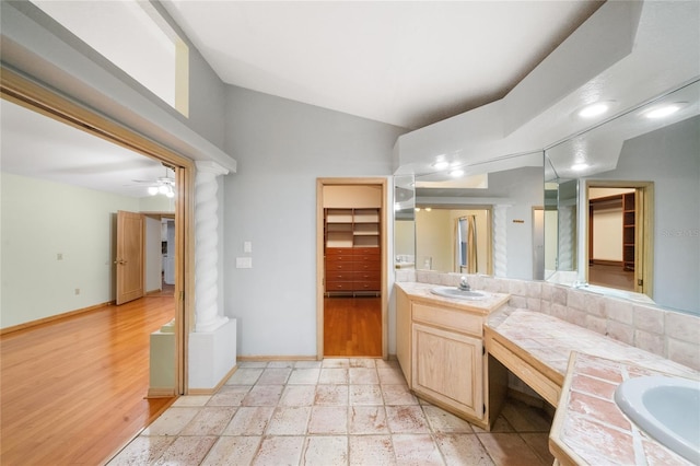 4265 Conway Place Cir, Orlando, FL 32812 - bathroom with vanity, baseboards, decorative columns, wood finished floors, and a ceiling fan