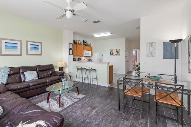 7663 Fitzclarence St, Kissimmee, FL 34747 - living area featuring dark wood-type flooring, a ceiling fan, electric panel, and baseboards
