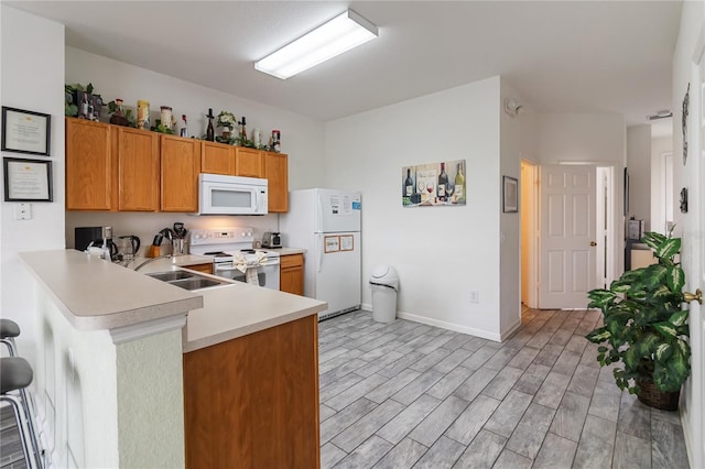 7663 Fitzclarence St, Kissimmee, FL 34747 - kitchen featuring white appliances, light countertops, a peninsula, a sink, and brown cabinets