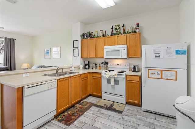 7663 Fitzclarence St, Kissimmee, FL 34747 - kitchen with white appliances, a sink, a peninsula, and light countertops