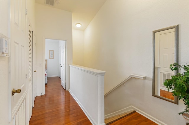7663 Fitzclarence St, Kissimmee, FL 34747 - hall featuring an upstairs landing, wood finished floors, and baseboards