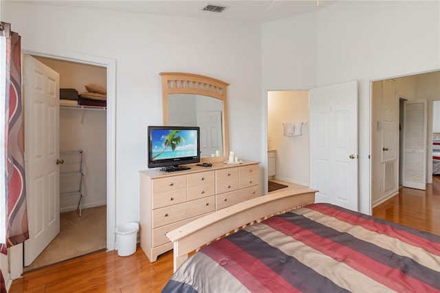 7663 Fitzclarence St, Kissimmee, FL 34747 - bedroom featuring light wood-style floors, a closet, a walk in closet, and connected bathroom