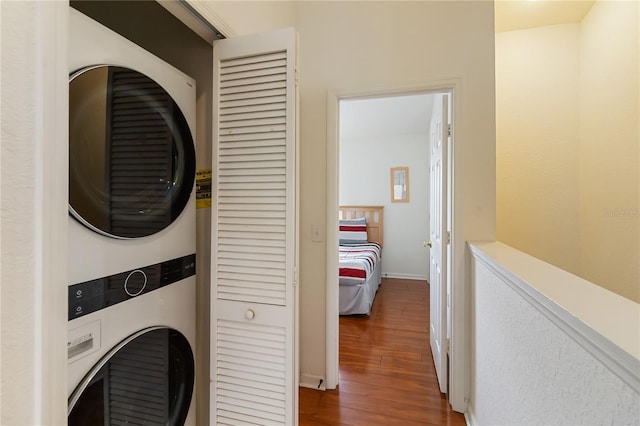 7663 Fitzclarence St, Kissimmee, FL 34747 - laundry room with estacked washer and dryer, wood finished floors, and baseboards