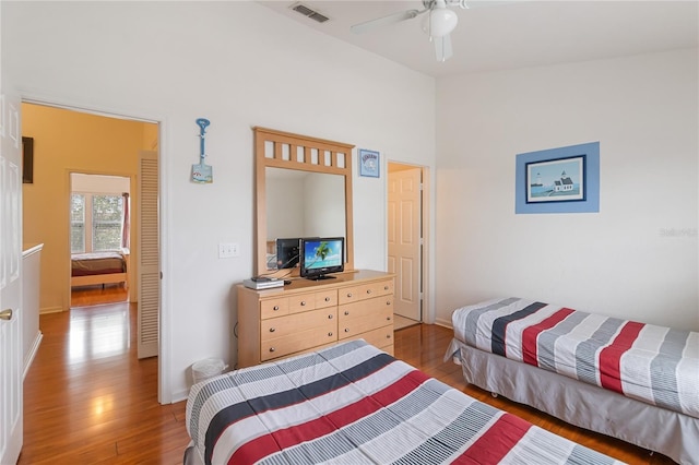 7663 Fitzclarence St, Kissimmee, FL 34747 - bedroom featuring light wood finished floors, baseboards, ceiling fan, and high vaulted ceiling