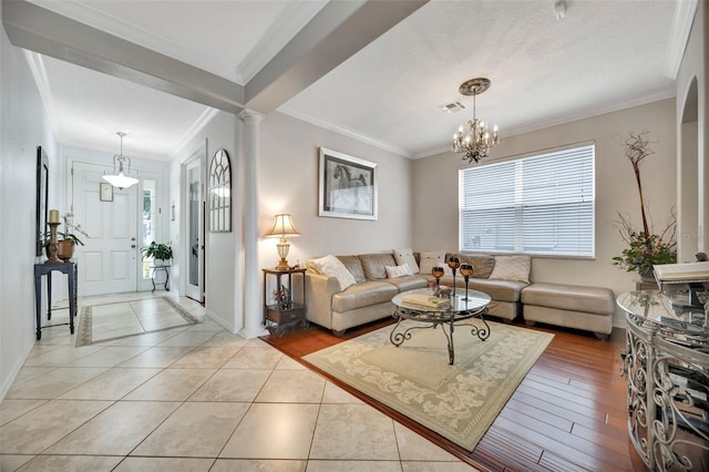 14231 Sonco Ave, Windermere, FL 34786 - living room with crown molding, baseboards, a chandelier, decorative columns, and light tile patterned floors