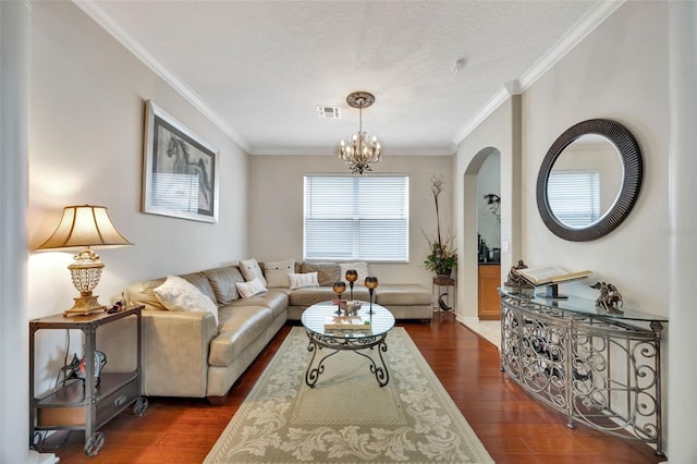 14231 Sonco Ave, Windermere, FL 34786 - living area featuring dark wood finished floors, ornamental molding, arched walkways, a chandelier, and a textured ceiling