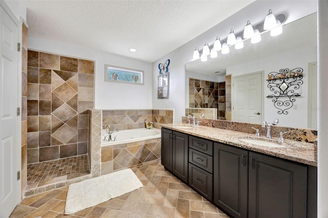 14231 Sonco Ave, Windermere, FL 34786 - bathroom with a bath, tiled shower, double vanity, a textured ceiling, and recessed lighting