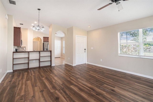 3319 Thistledown Ln, Land O Lakes, FL 34638 - unfurnished living room featuring arched walkways, a ceiling fan, dark wood-type flooring, baseboards, and recessed lighting