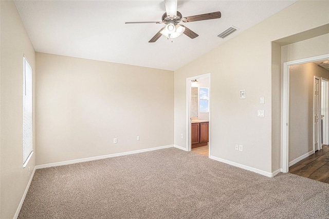 3319 Thistledown Ln, Land O Lakes, FL 34638 - unfurnished bedroom featuring carpet, baseboards, lofted ceiling, and connected bathroom