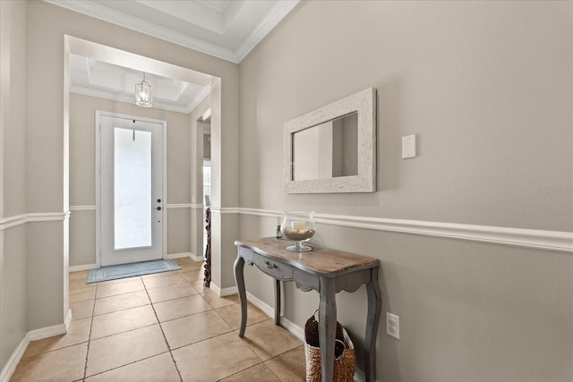 foyer with baseboards, light tile patterned floors, and crown molding