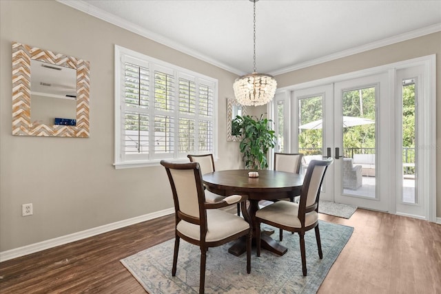 dining space featuring a chandelier, a wealth of natural light, french doors, and wood finished floors