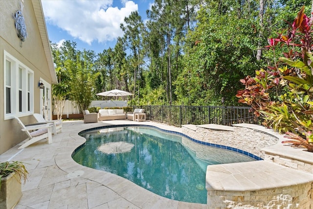 view of swimming pool with a fenced backyard, a patio area, outdoor lounge area, and a fenced in pool