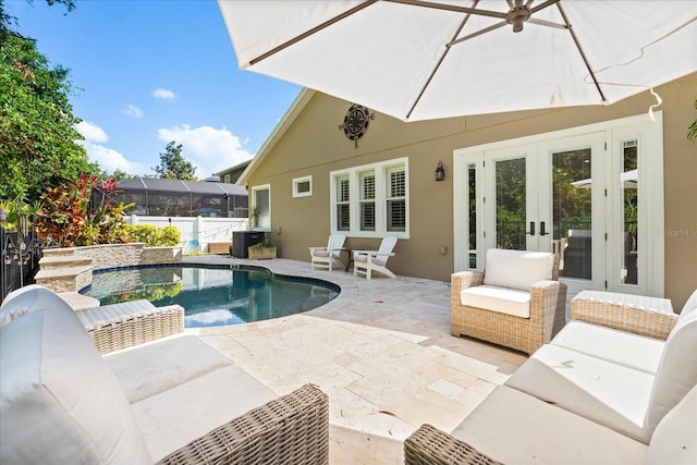 view of pool featuring an outdoor living space, french doors, a fenced in pool, a patio, and central AC