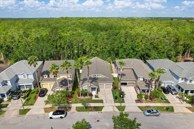 birds eye view of property featuring a forest view and a residential view