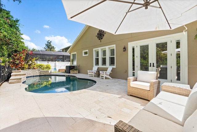 view of pool with a patio area, central air condition unit, and french doors