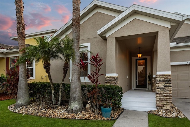 entrance to property featuring stone siding and stucco siding