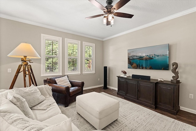 living room featuring wood finished floors, a ceiling fan, baseboards, and ornamental molding