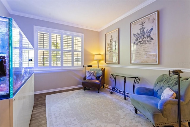 sitting room with crown molding, wood finished floors, and baseboards