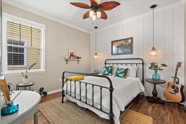 bedroom featuring crown molding, wood finished floors, baseboards, multiple windows, and ceiling fan