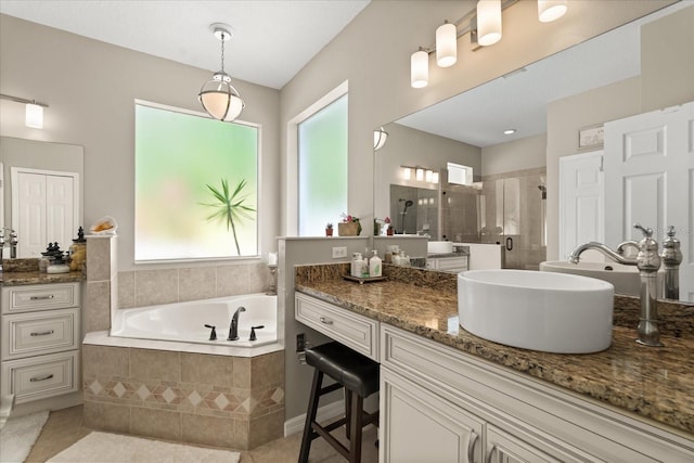 full bath with healthy amount of natural light, a stall shower, tile patterned flooring, and a garden tub