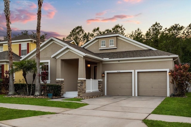 craftsman house featuring stucco siding, driveway, a garage, stone siding, and a shingled roof