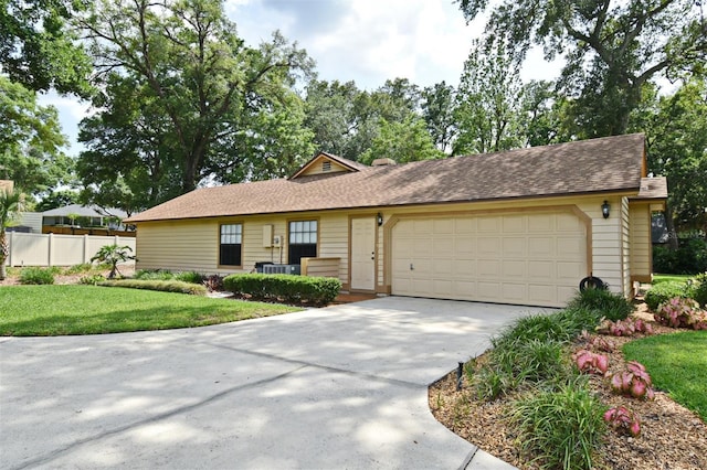 ranch-style house featuring an attached garage, concrete driveway, and roof with shingles