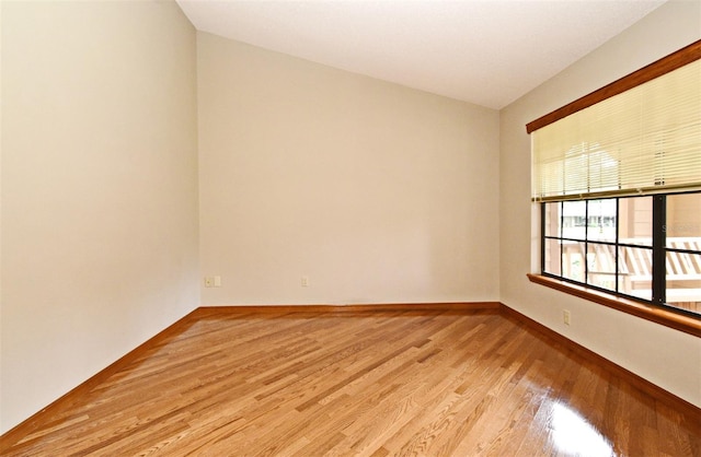 unfurnished room featuring light wood-style flooring and baseboards