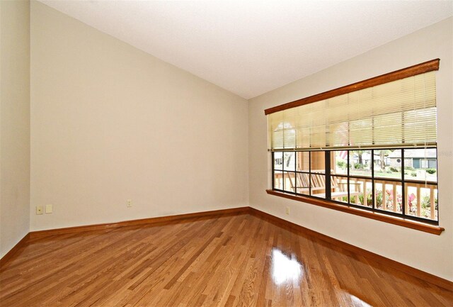 empty room featuring baseboards and wood finished floors