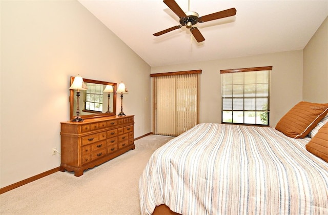 bedroom featuring vaulted ceiling, carpet, baseboards, and ceiling fan