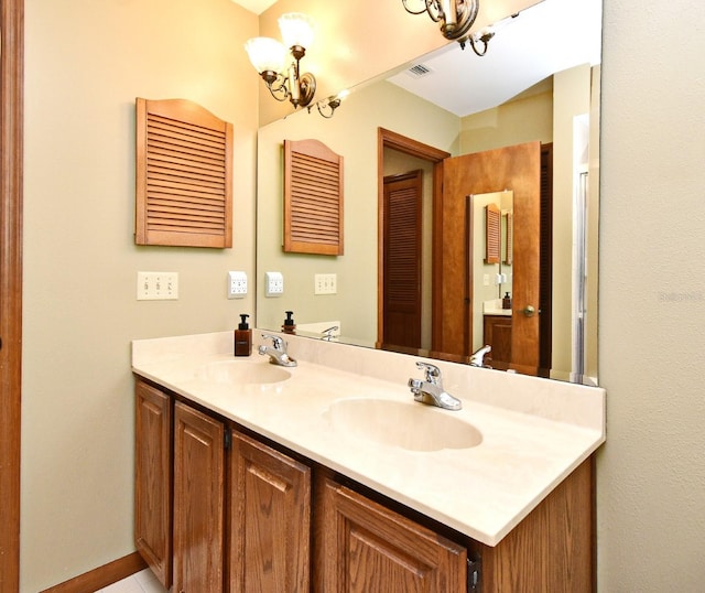 bathroom featuring double vanity and a chandelier