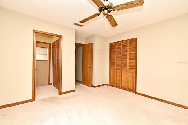 unfurnished bedroom featuring light colored carpet, baseboards, a closet, and ceiling fan