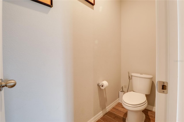 719 Tortugas St, Haines City, FL 33844 - bathroom with wood finished floors, toilet, and baseboards