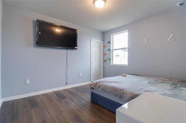 719 Tortugas St, Haines City, FL 33844 - bedroom featuring dark wood-style flooring, baseboards, and a textured ceiling