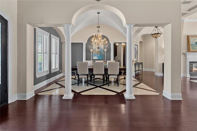 5909 Oxford Moor Blvd, Windermere, FL 34786 - dining area featuring ornate columns, hardwood / wood-style flooring, arched walkways, and baseboards