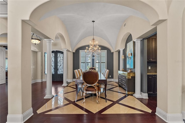 5909 Oxford Moor Blvd, Windermere, FL 34786 - dining space featuring ornate columns, inlaid floor details, a chandelier, baseboards, and vaulted ceiling