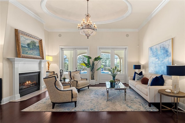 5909 Oxford Moor Blvd, Windermere, FL 34786 - living area featuring wood-type flooring, a chandelier, a raised ceiling, crown molding, and a fireplace with flush hearth