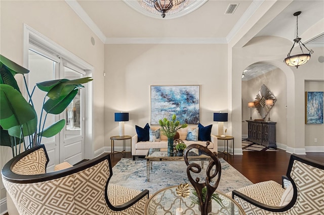 5909 Oxford Moor Blvd, Windermere, FL 34786 - living area with wood finished floors, baseboards, arched walkways, and ornamental molding
