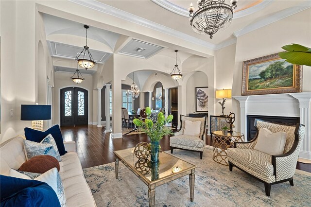 5909 Oxford Moor Blvd, Windermere, FL 34786 - living area featuring arched walkways, a chandelier, wood-type flooring, crown molding, and baseboards