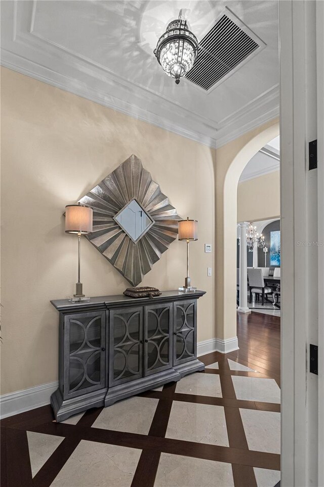 5909 Oxford Moor Blvd, Windermere, FL 34786 - corridor with inlaid floor details, arched walkways, a chandelier, baseboards, and crown molding