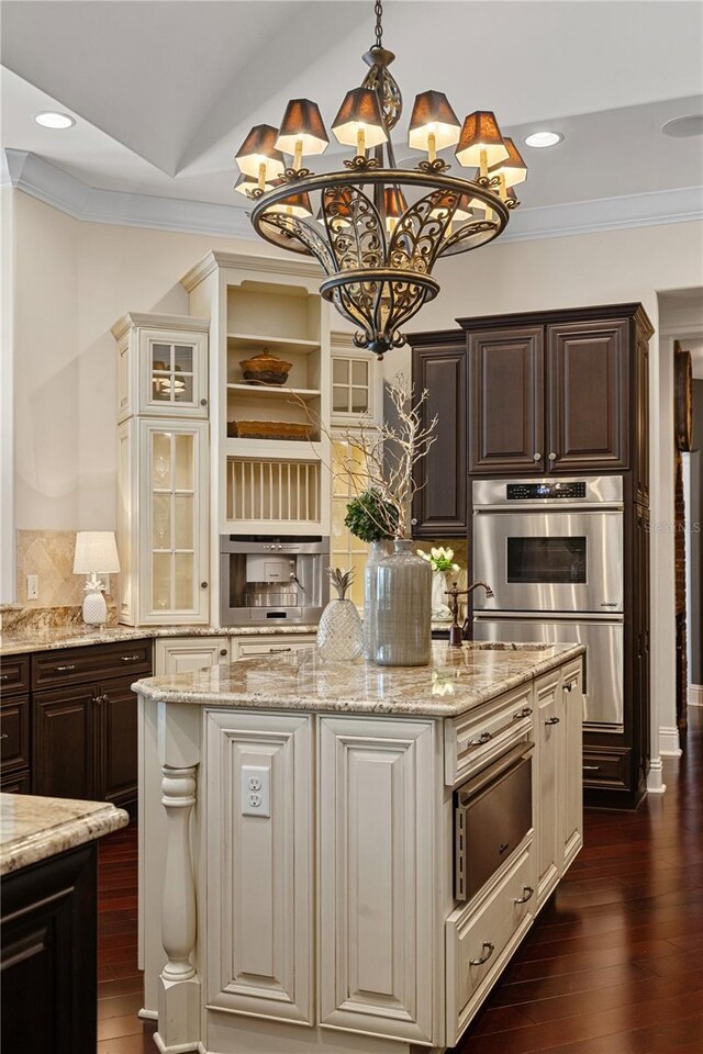 5909 Oxford Moor Blvd, Windermere, FL 34786 - kitchen with a chandelier, a center island with sink, ornamental molding, dark brown cabinets, and decorative backsplash