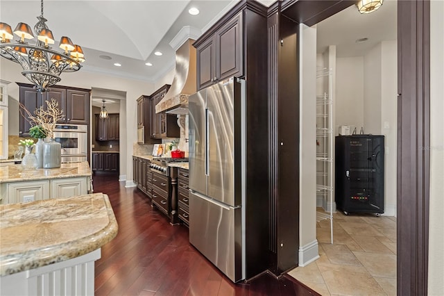 5909 Oxford Moor Blvd, Windermere, FL 34786 - kitchen featuring appliances with stainless steel finishes, a chandelier, ornamental molding, light stone counters, and dark brown cabinets