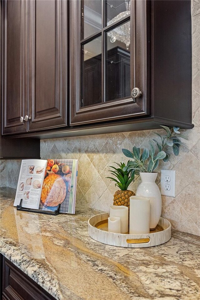 5909 Oxford Moor Blvd, Windermere, FL 34786 - kitchen view of dark brown cabinets, tasteful backsplash, and light stone countertops